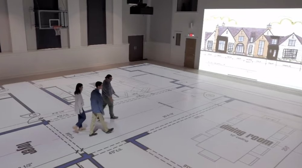 Walk Your Plans clients are seen walking through plans for their home inside the company's studios