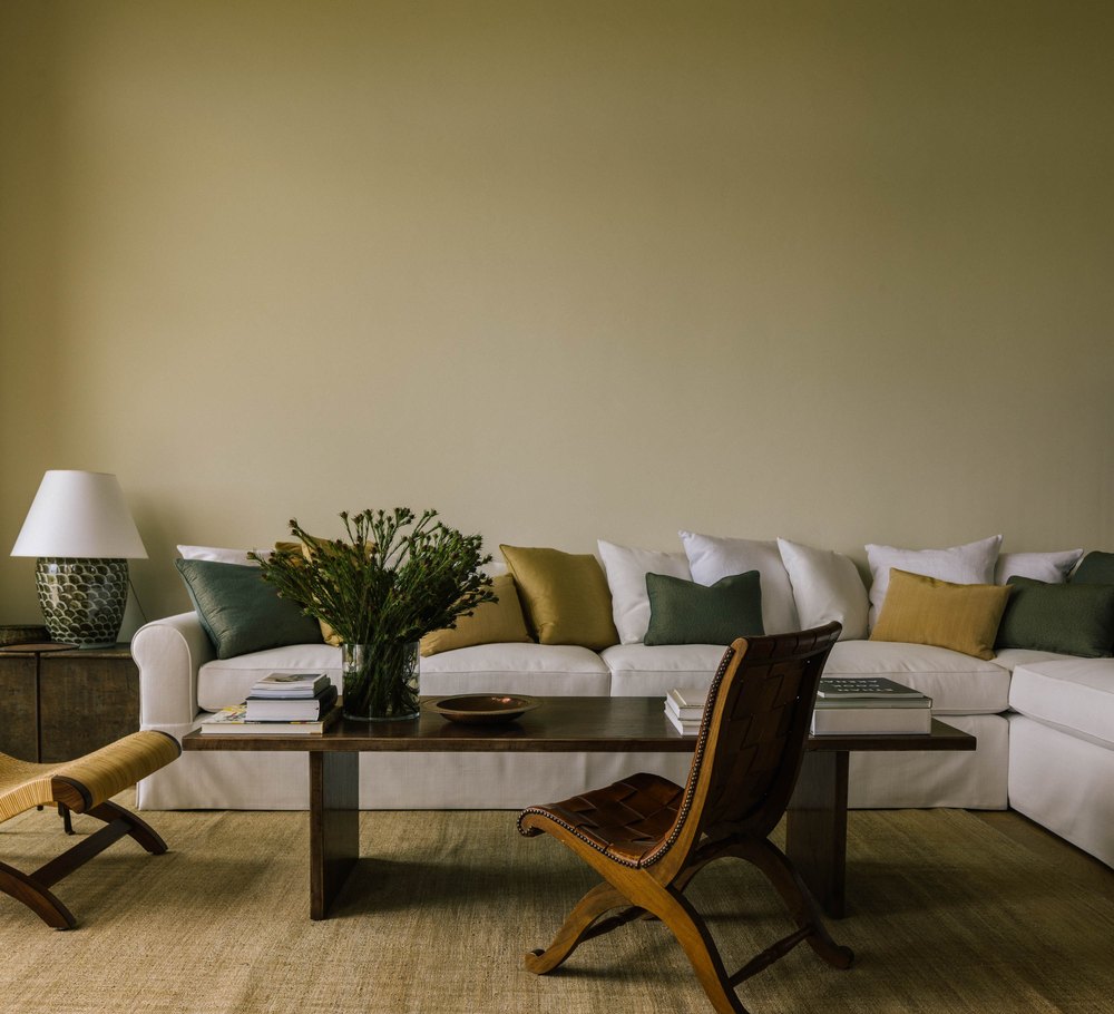 The living room's cream couch is indicative of the neutral, yet warm, color palette.