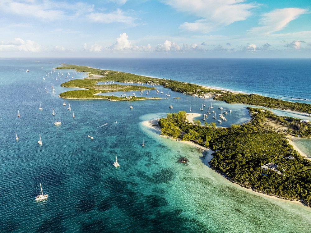 Beautiful Aerial View of Famous Chat'n'chill Conch bar in Stocking Island (Exuma - Bahamas) near George Town with many boats and Sailing Yachts Anchored