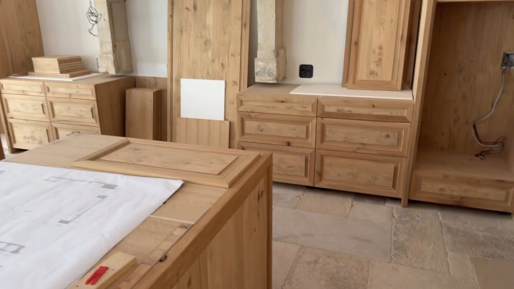 Unfinished Custom Wood Cabinetry and Architectural Blueprints on Construction Site