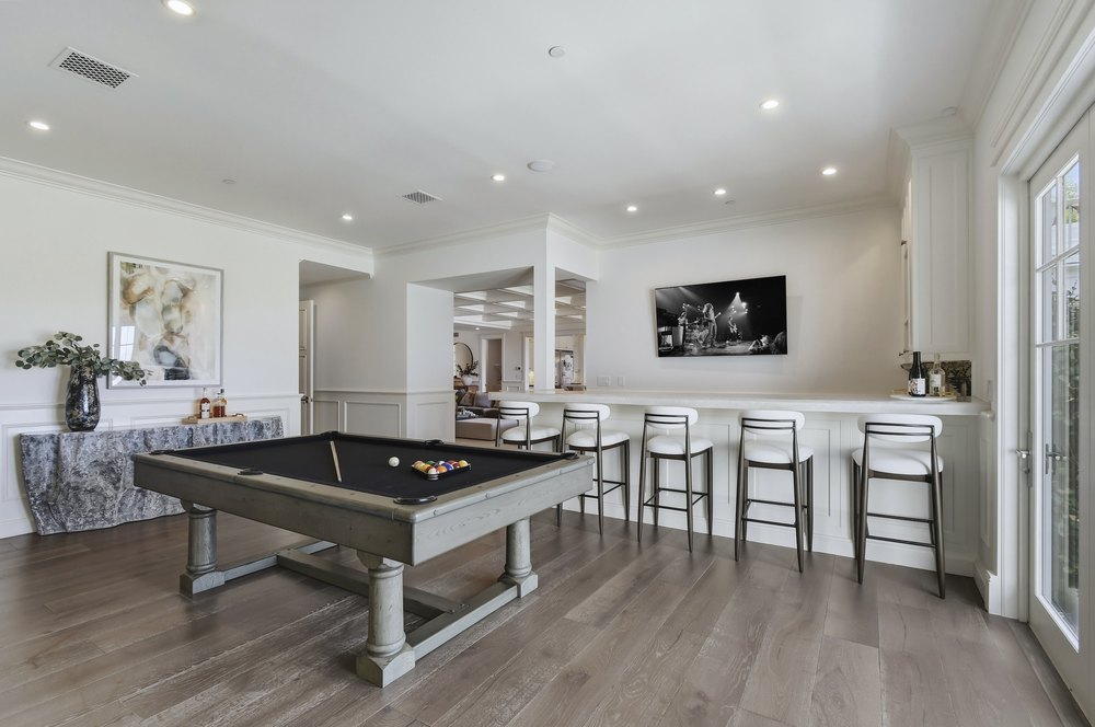 Game Room Area featuring Foosball Table, Bar Island, and Hardwood Flooring