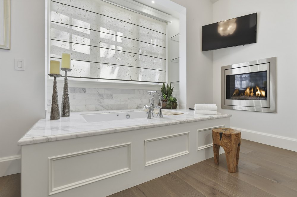 Bathroom Vanity Area with Long Countertop, Dual Sinks, and Large Mirror