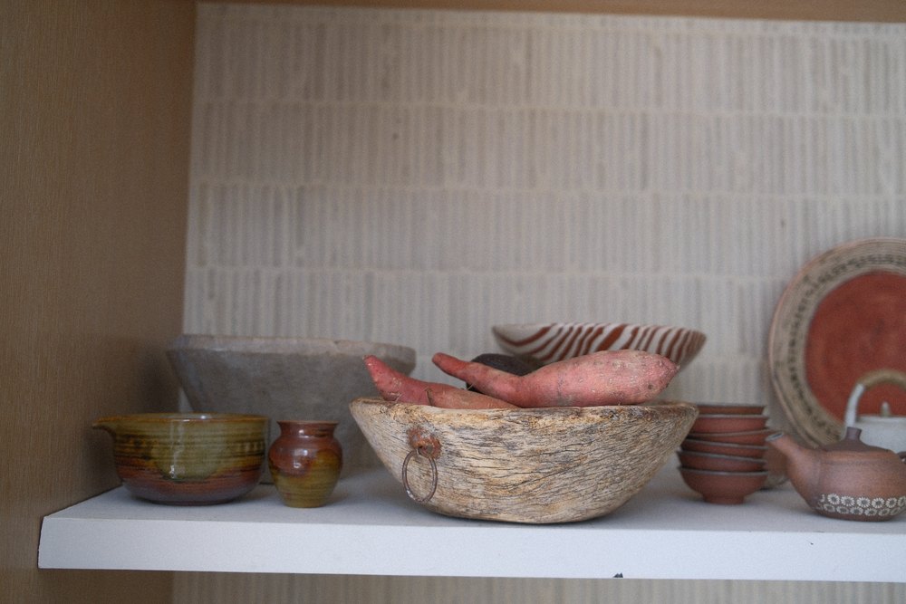 She also keeps a wooden bowl for potatoes within reach.