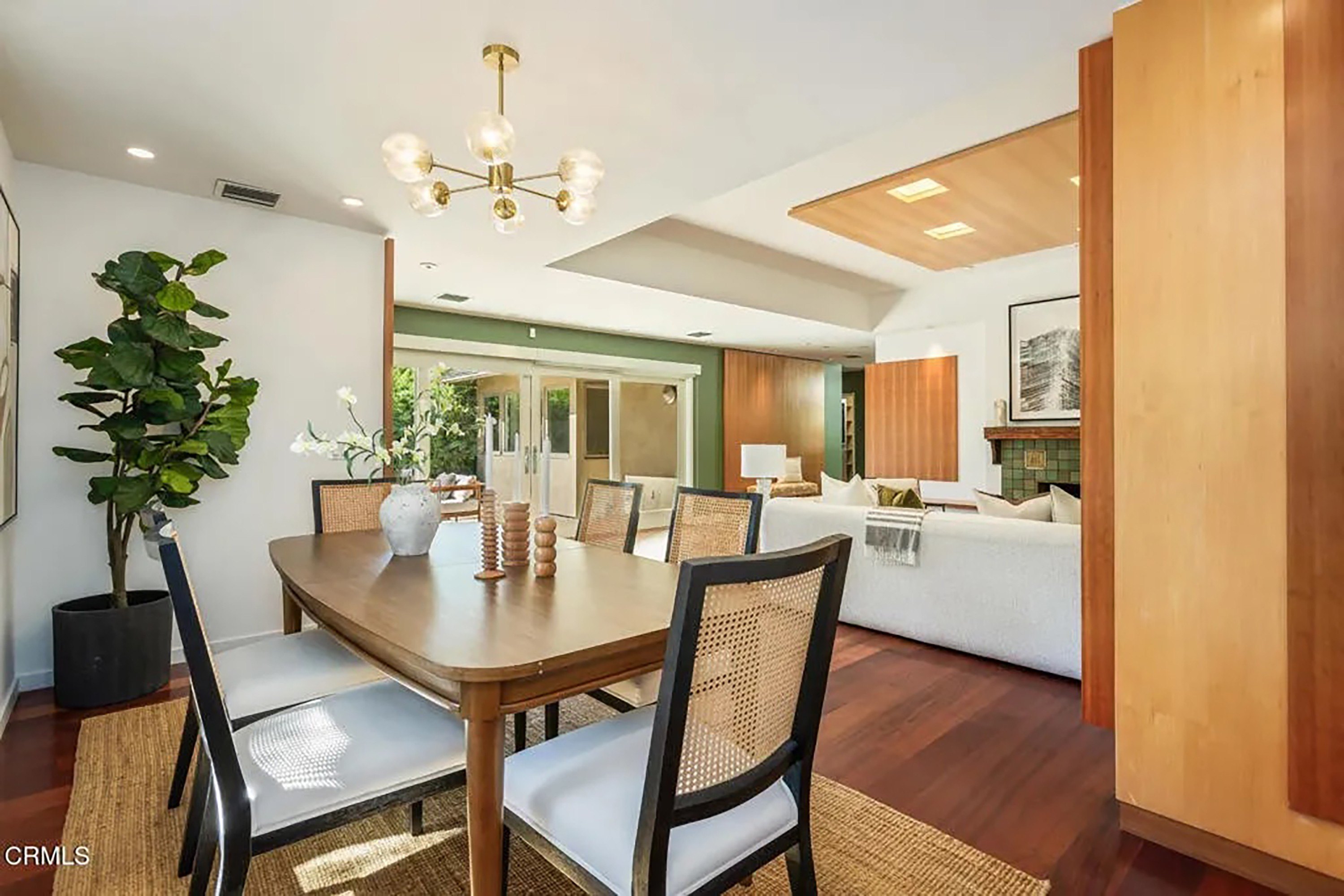 Mid-Century Modern Dining Room with Woven Chairs and Hardwood Flooring