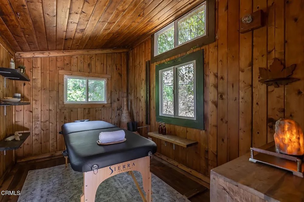 Rustic Wood-Paneled Massage Room with Portable Treatment Table